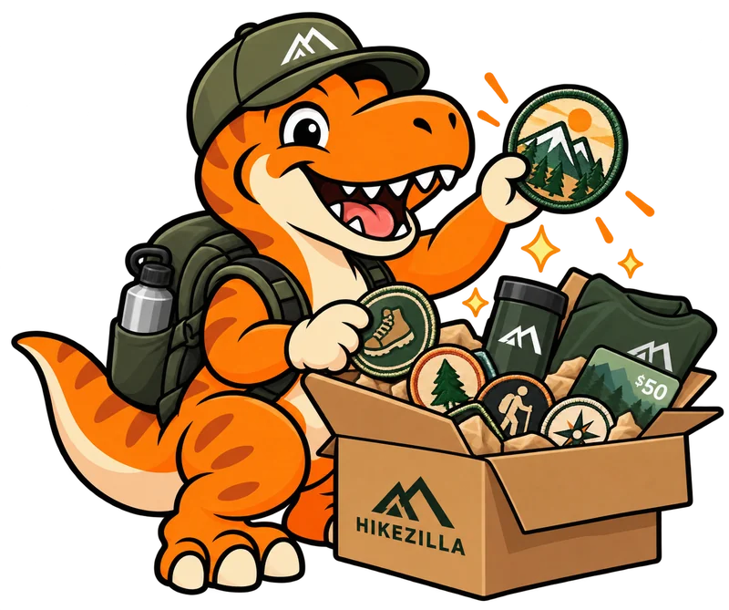Rex the dinosaur celebrating a box of Hikezilla rewards, patches and gear