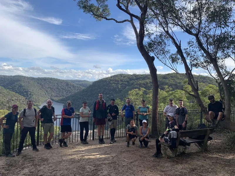 A hiking group gathered at a mountain lookout